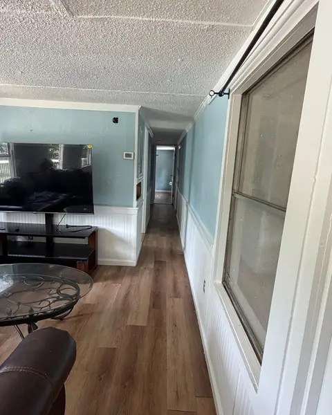 Hallway and living room with a clean wood floor