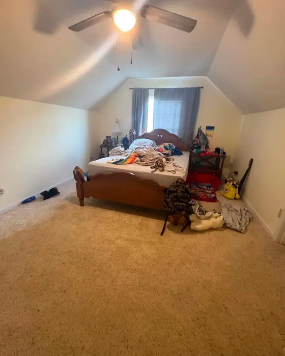 Before: bedroom with clothes and things on the bed and carpet