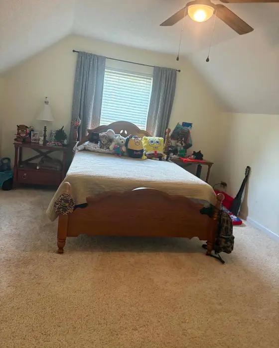 After: the same bedroom with the bed made and the carpet clean