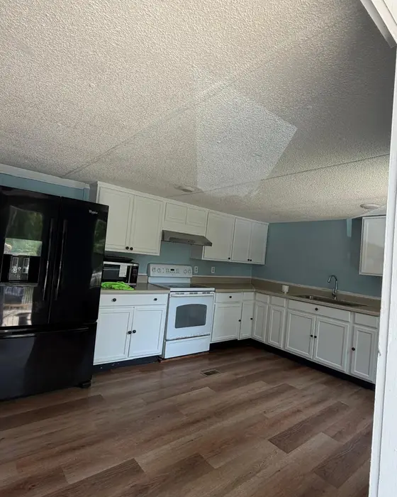 After: the same kitchen cleared, with a clean wood floor