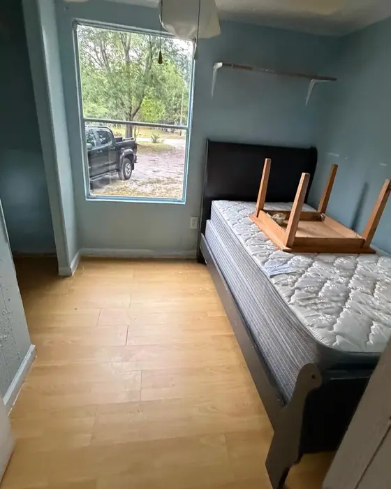 Before: room with a mattress and disassembled furniture