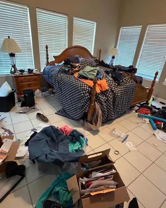 Before: bedroom with clothes, boxes and things all over the floor