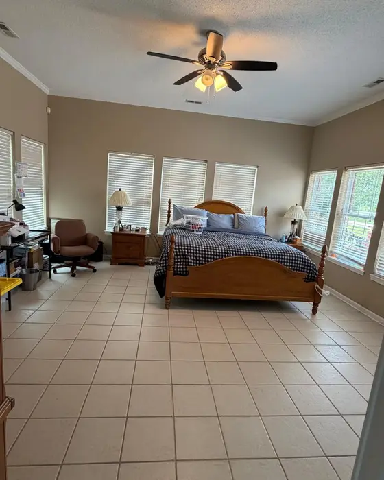After: the same bedroom tidied up, bed made and tile floor clean