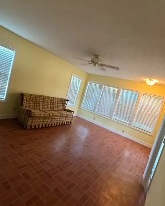 After: the same living room empty, clean and with a shiny floor