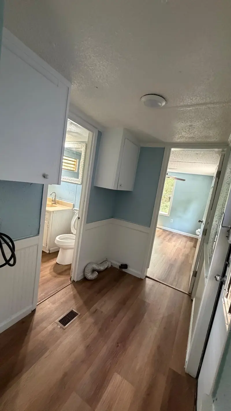 Newly remodeled hallway with white cabinets and a clean floor